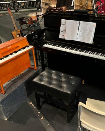 Two pianos set up next to each other on a stage