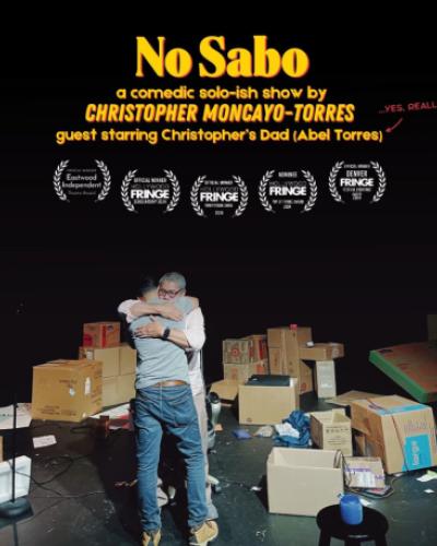 No Sabo: A comedic solo-ish show by Christopher Moncayo-Torres, guest starring Christopher’s dad (Abel Torres) (yes, really)  Christopher and his dad Abel hugging on a stage surrounded by boxes and small objects on the floor.